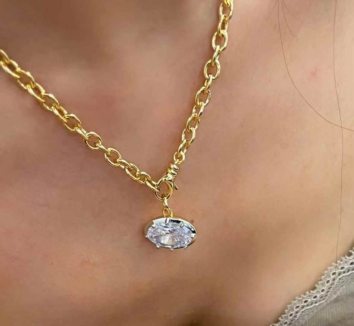 Oval diamond simulant pendant in 18K gold vermeil and sterling silver; pendant only