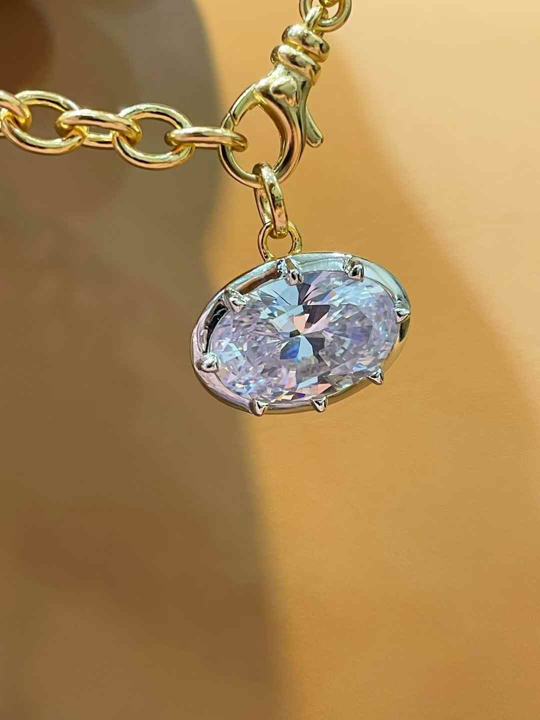 Oval diamond simulant pendant in 18K gold vermeil and sterling silver; pendant only