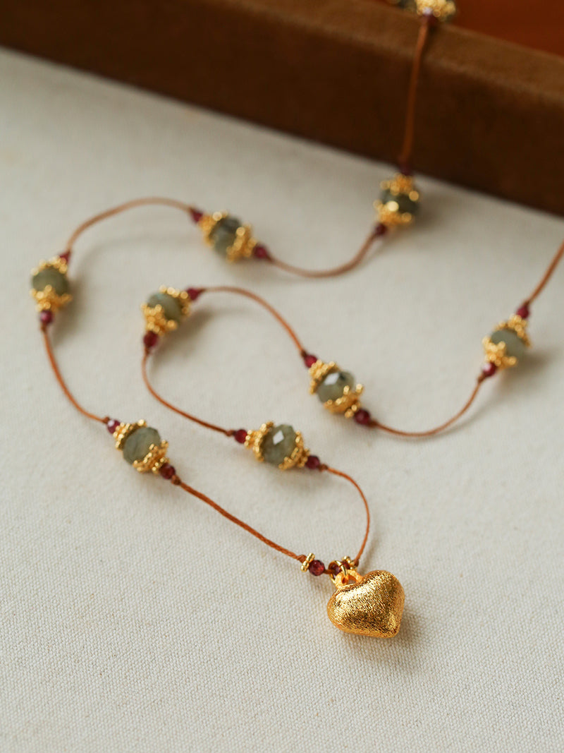 Heart pendant necklace arranged on a white display