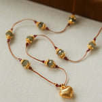 Heart pendant necklace arranged on a white display