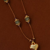 Gold heart pendant and labradorite bead details