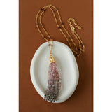 Sicilian Sunset pink and smoky grey gemstone tassel necklace on a ceramic dish