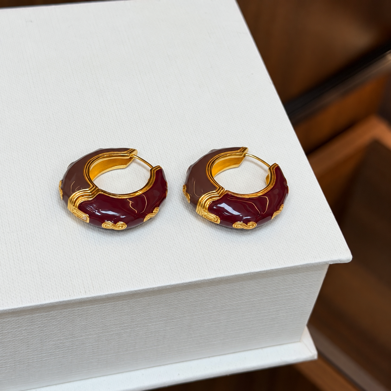 Burgundy enamel sculpted hoop earrings - close-up pair