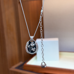 Black and silver four-leaf clover pendant necklace - close-up