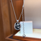 Black and silver four-leaf clover pendant necklace - close-up