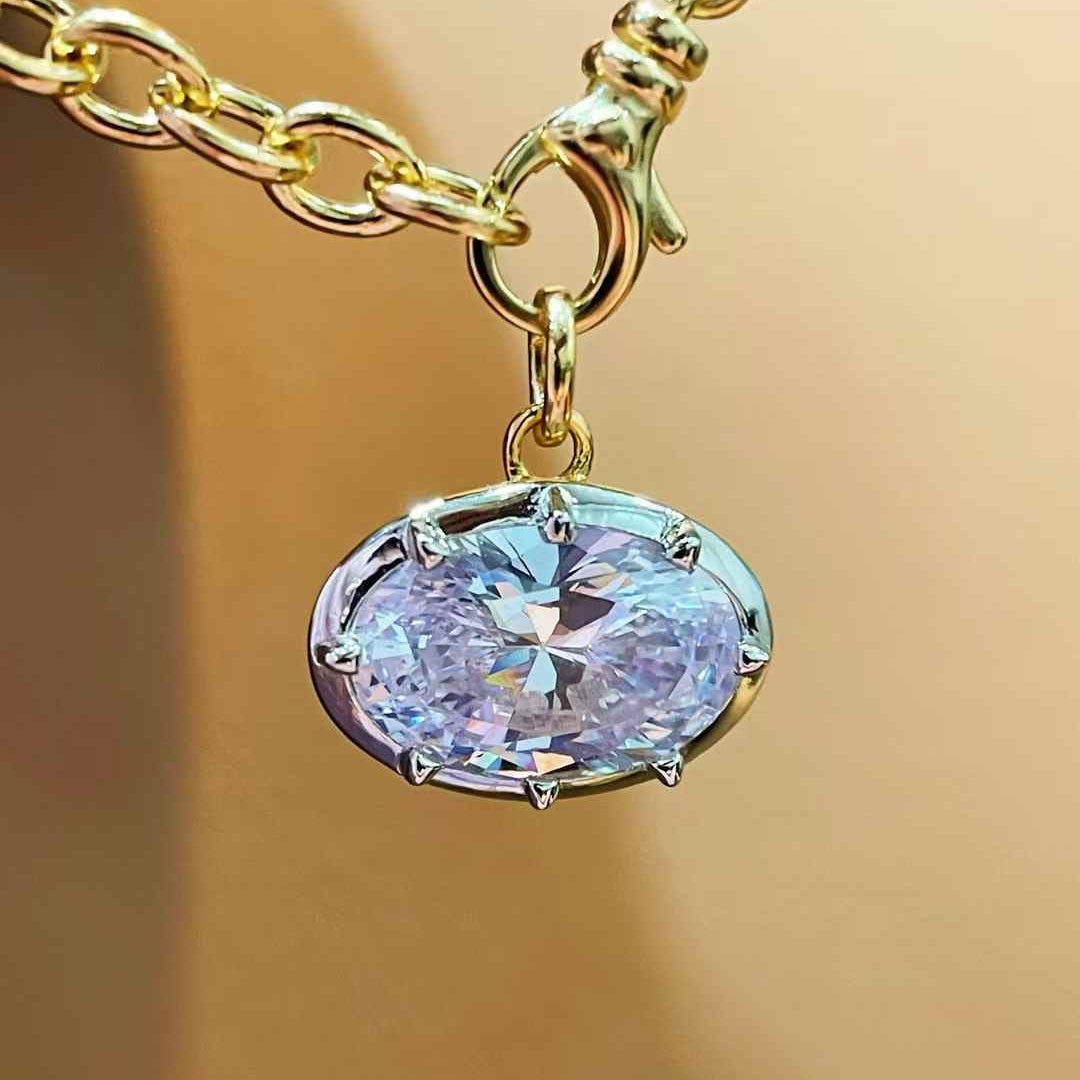 Oval diamond simulant pendant in 18K gold vermeil and sterling silver; pendant only