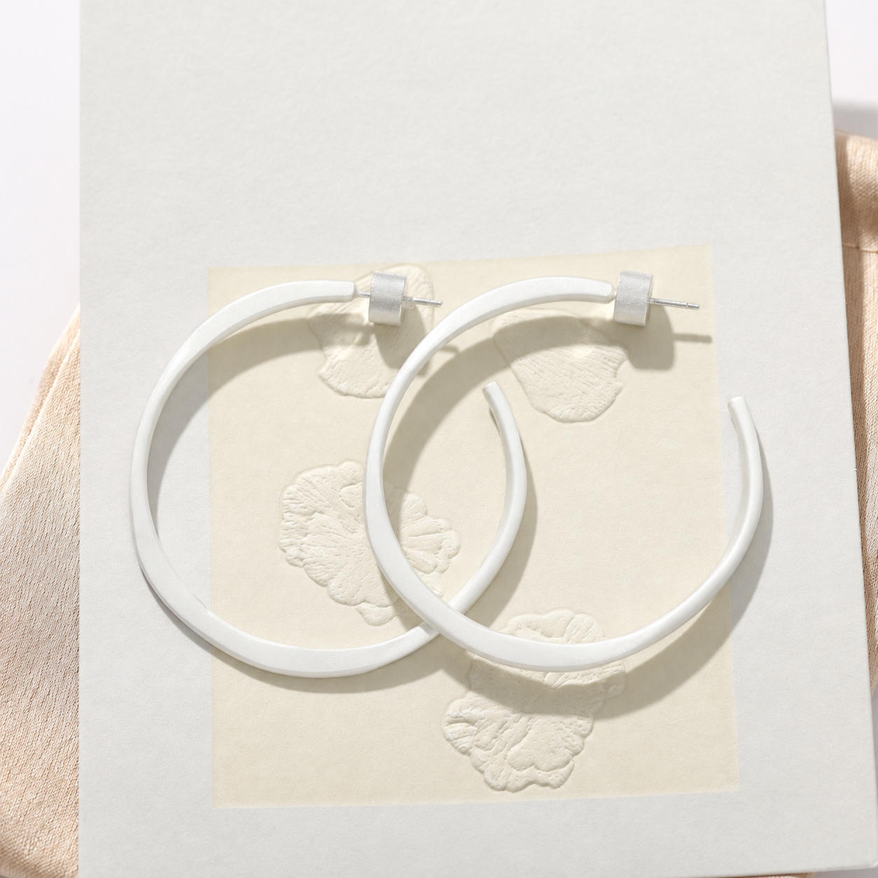 Sculptural white C-hoop statement earrings in 925 sterling silver