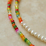 Close-up of multicoloured glass beads and freshwater pearl transition