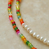 Close-up of multicoloured glass beads and freshwater pearl transition