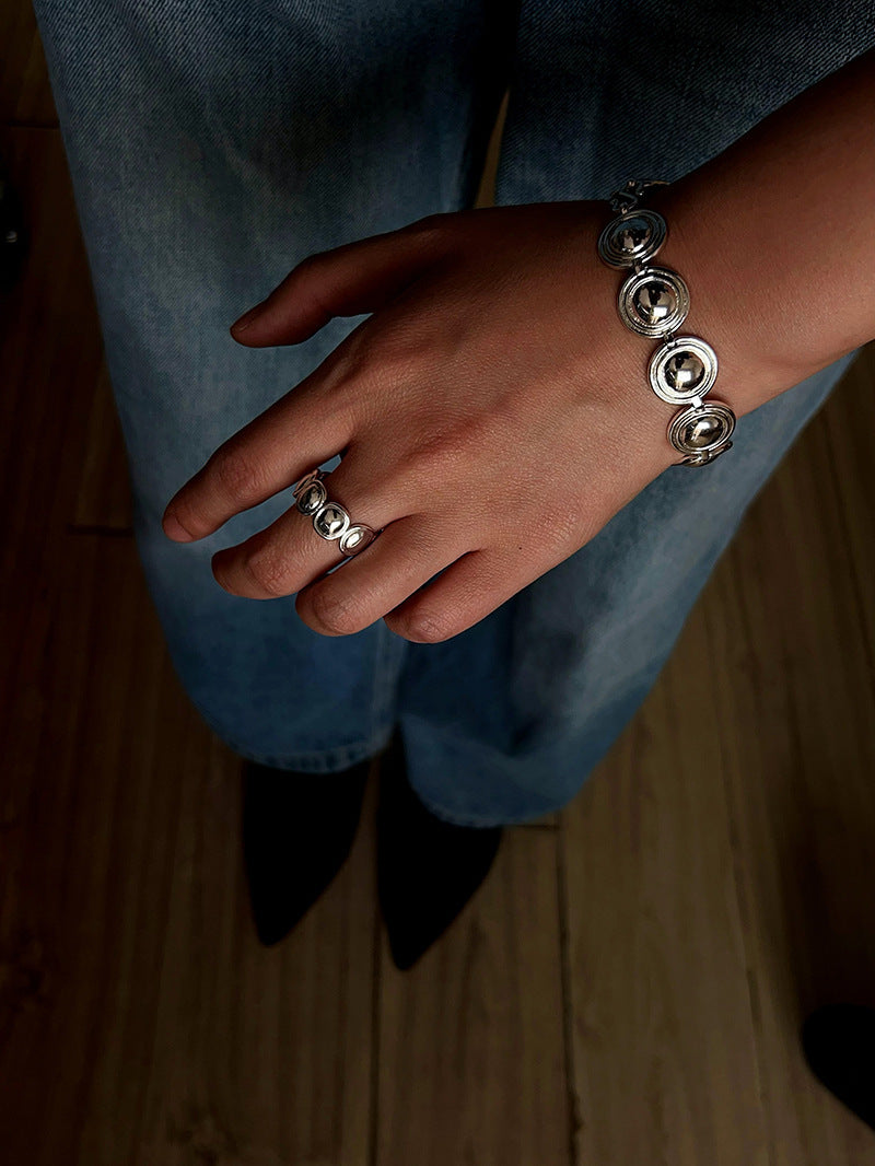 Silver oval dome bracelet worn with a blue shirt