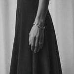 Oval dome bracelet shown in a monochrome outfit
