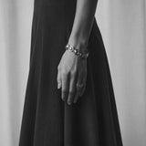 Oval dome bracelet shown in a monochrome outfit