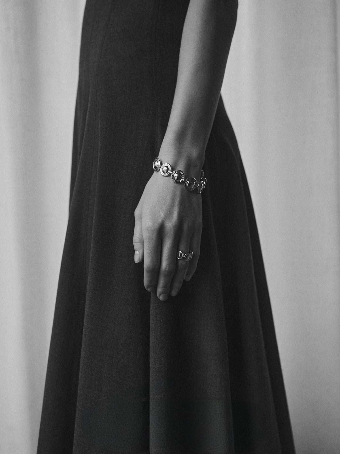 Oval dome bracelet shown in a monochrome outfit