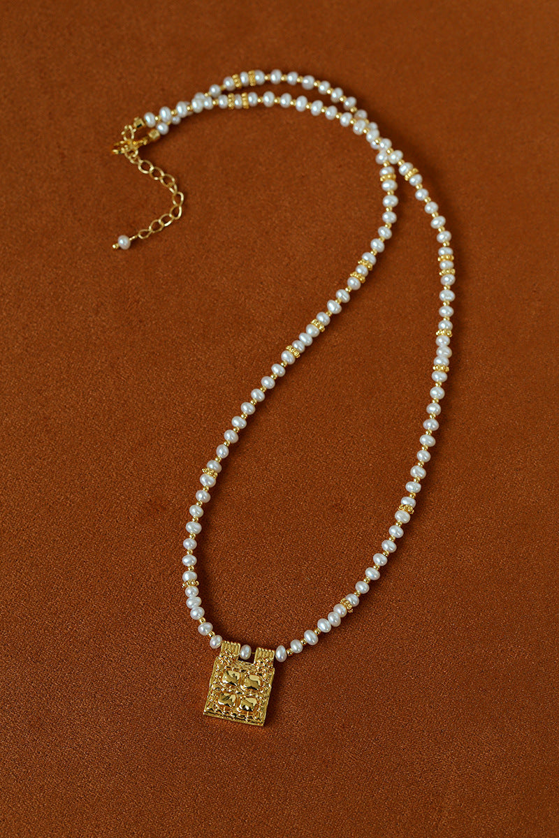 Freshwater pearl pendant necklace laid flat
