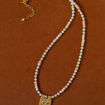 Freshwater pearl pendant necklace laid flat