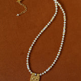 Freshwater pearl pendant necklace laid flat