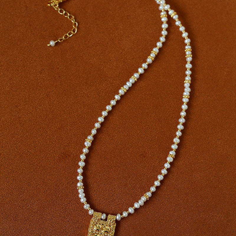 Freshwater pearl pendant necklace laid flat
