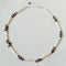 Toothpick pearl and garnet necklace arranged in a circle