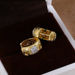 Gold floral cubic zirconia hoop earrings in jewelry box