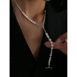 Model styling the pearl and silver chain necklace with a front Y-shaped drop