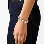 Silver oval dome link bracelet worn with jeans