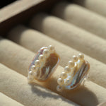 Elongated baroque pearl studs with pearl rows in a jewellery tray
