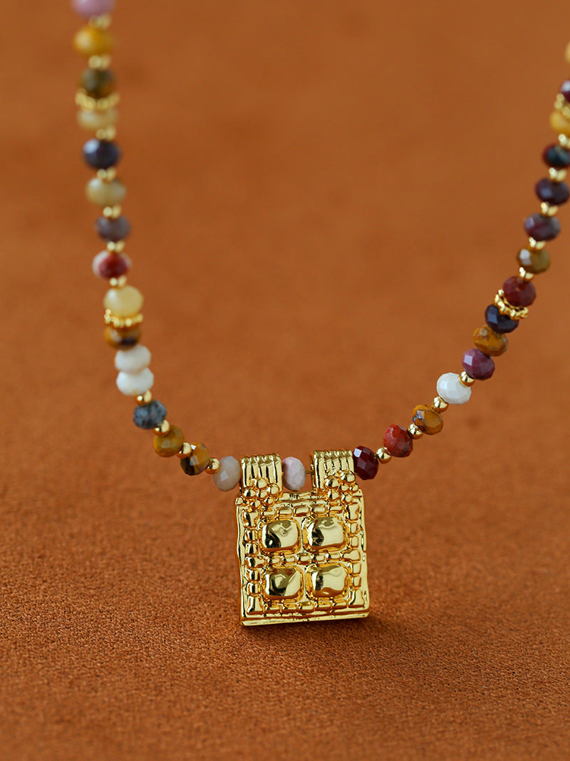 Close-up of multicolor stone beads and square pendant