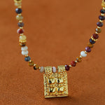 Close-up of multicolor stone beads and square pendant