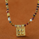 Close-up of multicolor stone beads and square pendant