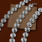 Silver oval dome link bracelets laid flat