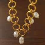 Hammered circular link necklace with suspended baroque pearls