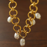 Hammered circular link necklace with suspended baroque pearls