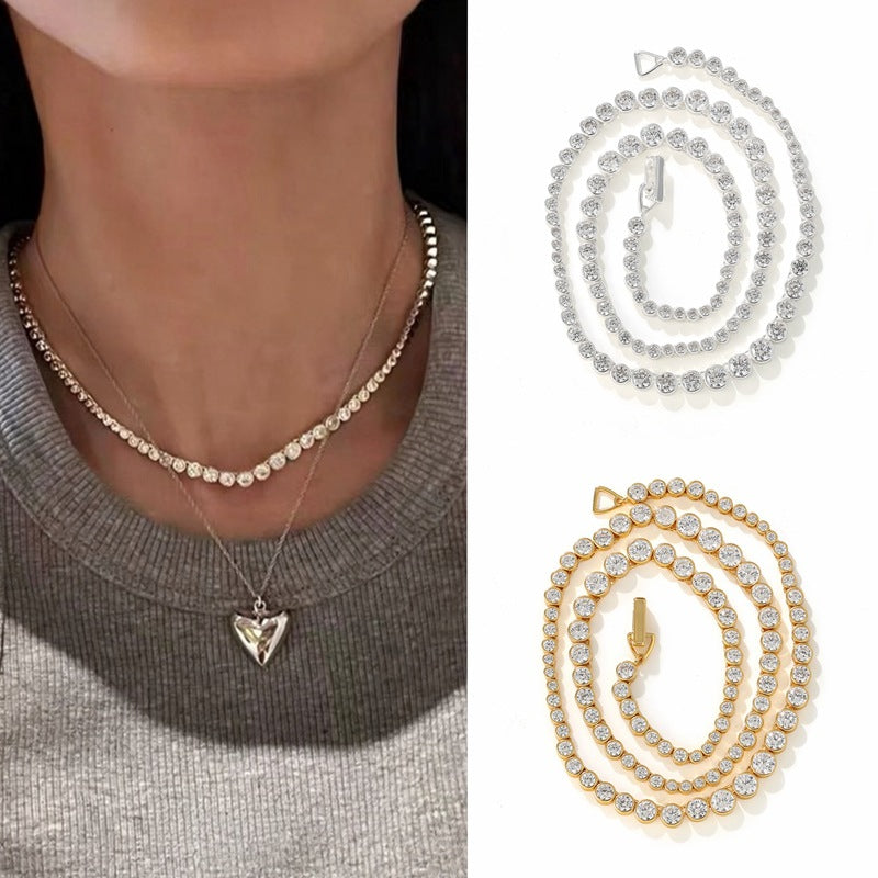 Graduated CZ tennis necklace styled with a grey top