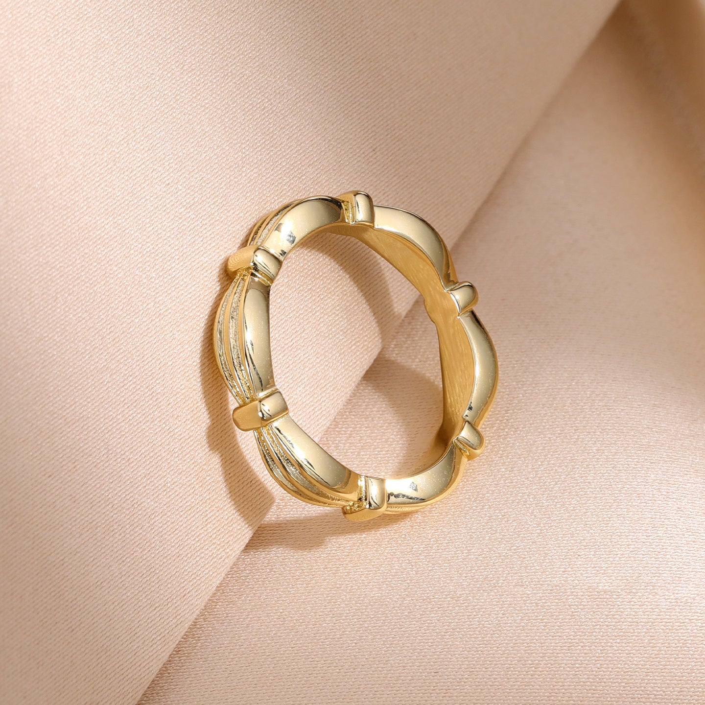 Gold sculpted ribbon band ring - angled view