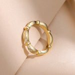 Gold sculpted ribbon band ring - angled view