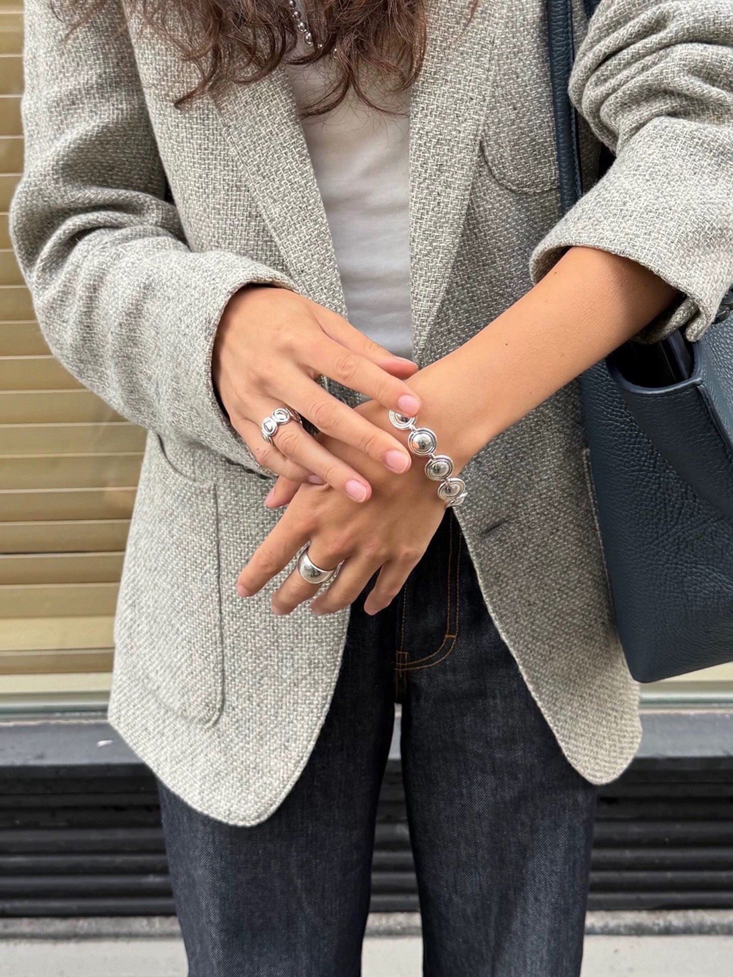 Oval dome link bracelet styled with a grey jacket