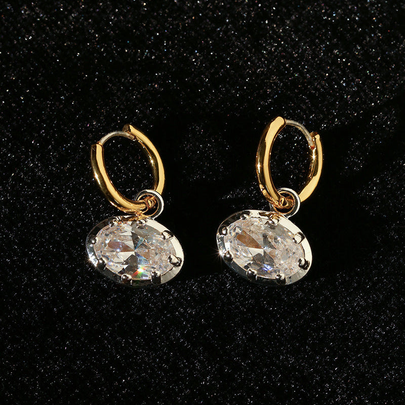 Vintage oval 5A cubic zirconia huggie drop earrings on black velvet