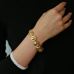 Gold oval dome link bracelet worn on the wrist