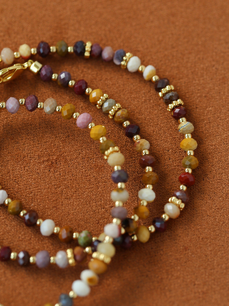 Close-up of multicolor natural stone beads and gold-tone accents