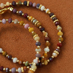 Close-up of multicolor natural stone beads and gold-tone accents