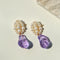 Pearl cluster stud earrings with purple sculpted glass drops