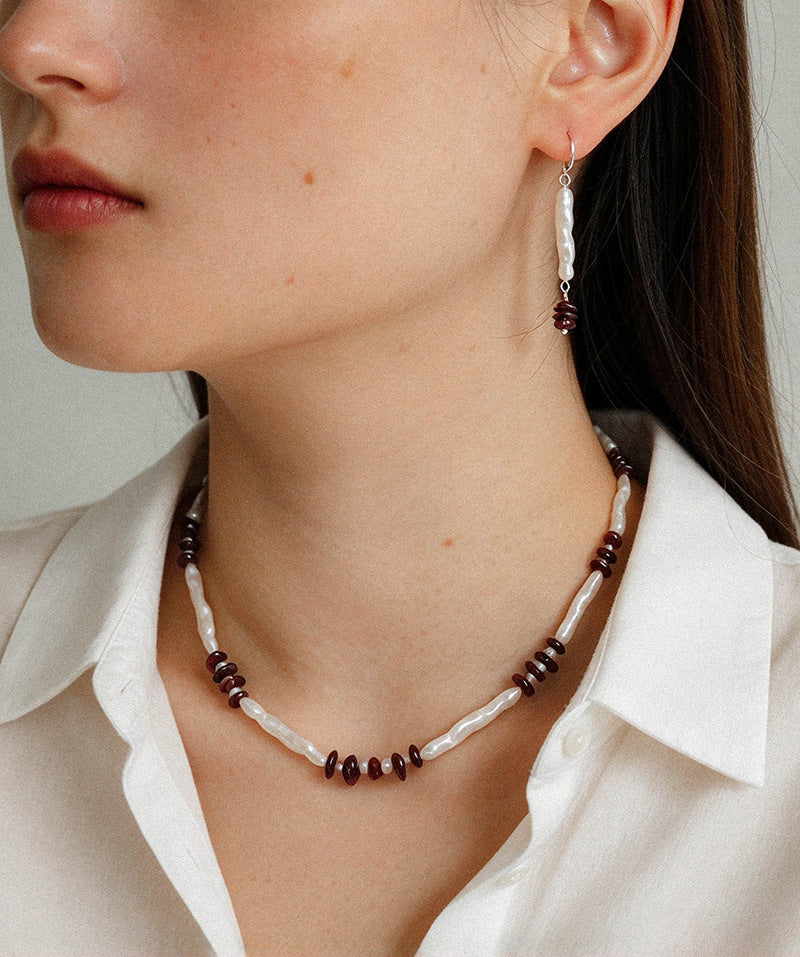 Freshwater pearl and garnet necklace worn with matching drop earrings
