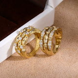 Pavé and scattered cubic zirconia ribbon rings - side view