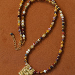 Multicolor stone pendant necklace laid flat
