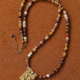 Multicolor stone pendant necklace laid flat