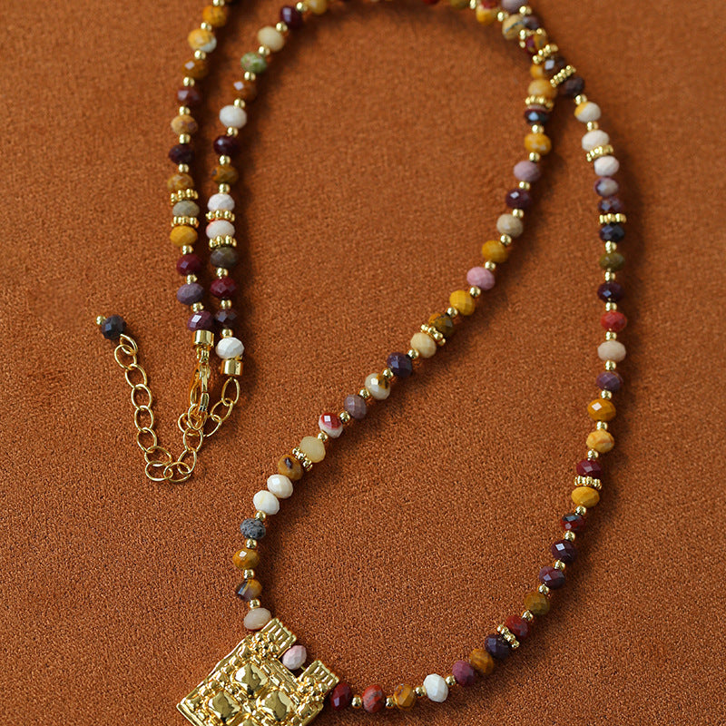Multicolor stone pendant necklace laid flat