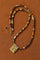 Multicolor stone pendant necklace laid flat