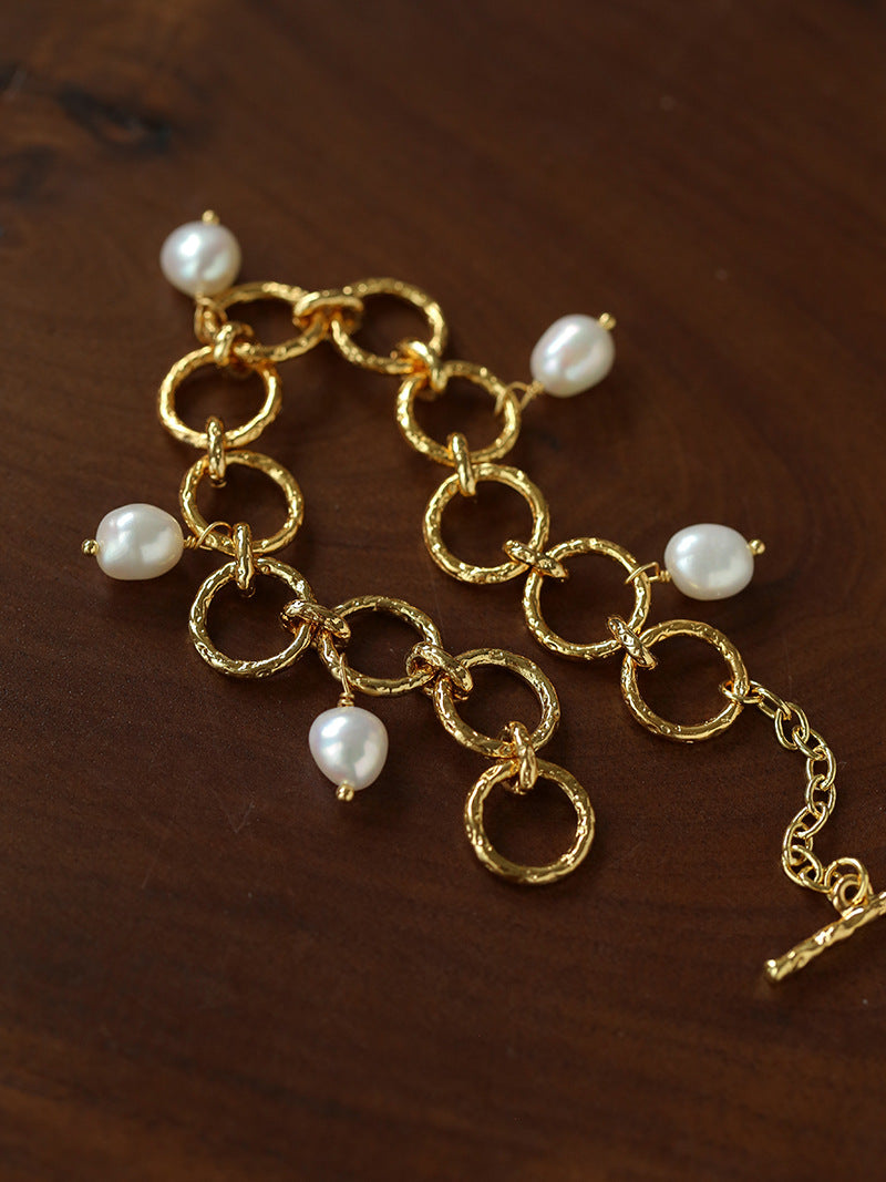 Textured circular link bracelet with suspended freshwater pearls
