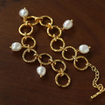 Textured circular link bracelet with suspended freshwater pearls