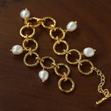 Textured circular link bracelet with suspended freshwater pearls